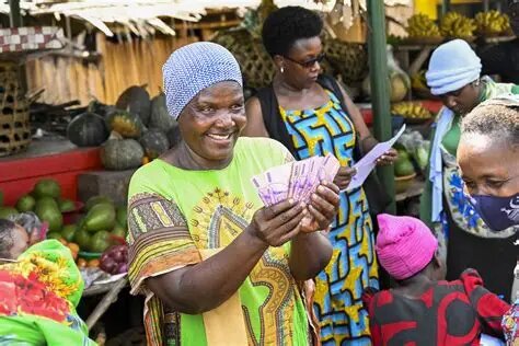 A market trader holding a fan of cash, counting savings
